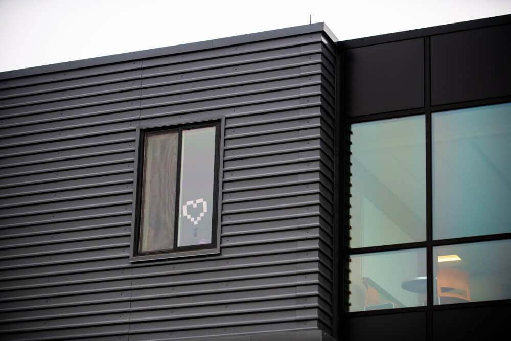    A heart made of Post-it Notes decorates the window of a room in the Holton-Hooker Learning & Living Center.