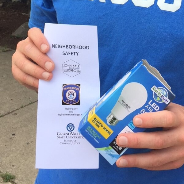 Nearly 40 students in the GVSU Police Academy joined members of the John Ball Area Neighborhood Association and the Grand Rapids Police Department June 23 to hand out nearly 875 LED light bulbs and crime prevention brochures to residents of the West Side.