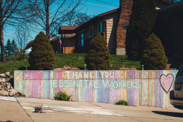 chalk art on wall reads Thank you essential workers
