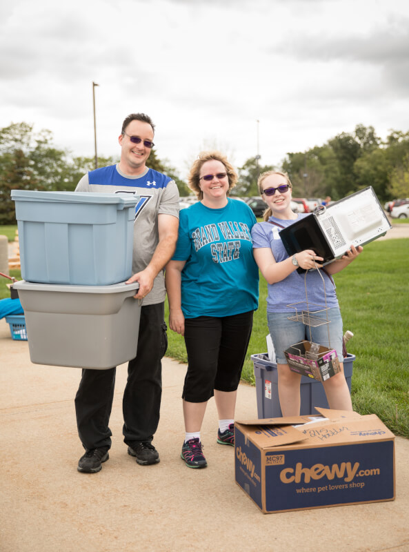 A photo of family members and a student moving in last year.