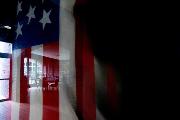 An american flag with a shadow in front of it