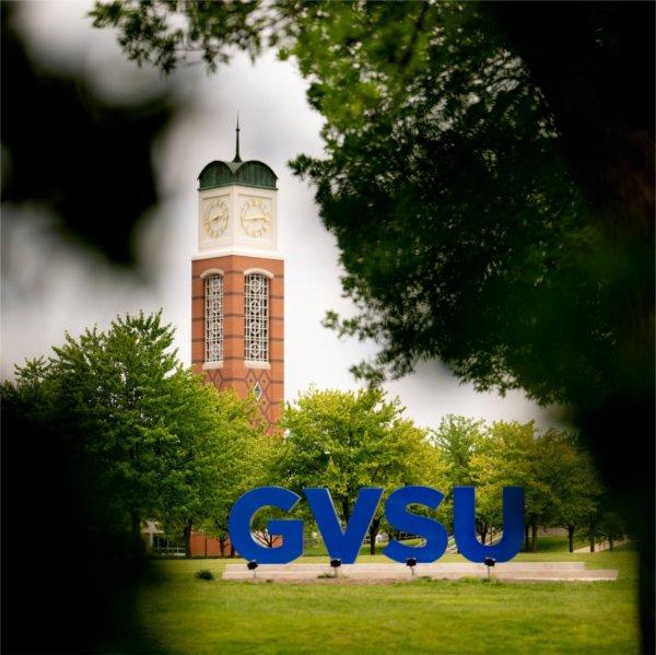 Cook Carillon tower behind GVSU letters on lawn