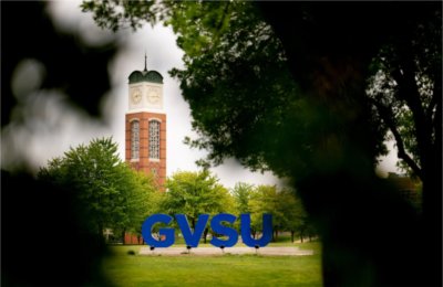 Cook Carillon tower behind GVSU letters on lawn