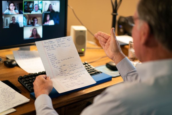 Haas reads from notes while teaching an undergraduate class from his home office.