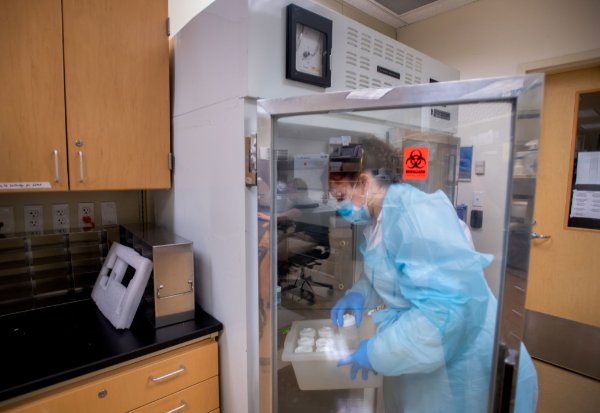 A student processes a wastewater sample at the Cook-DeVos Center for Health Sciences.