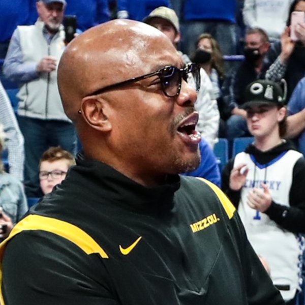 Cornell Mann shakes hands with another coach following a game.