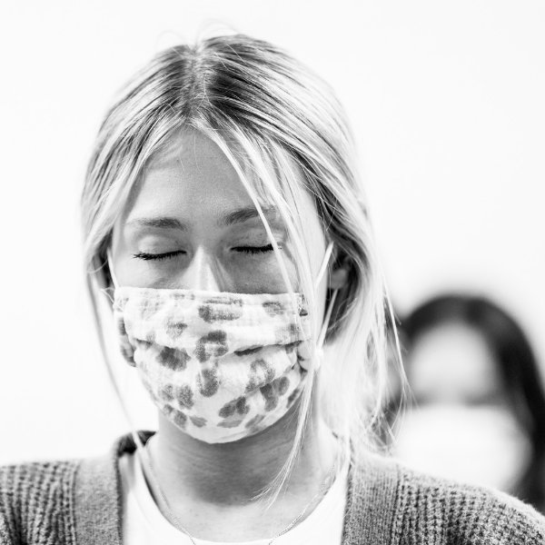 student in face mask with eyes closed during a mindfulness class