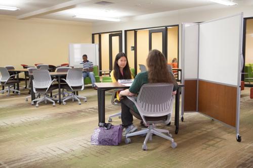 Students William Banks, Yuanjun Qi and Tracy Priefer were among the first to discover the expanded Steelcase Library space.