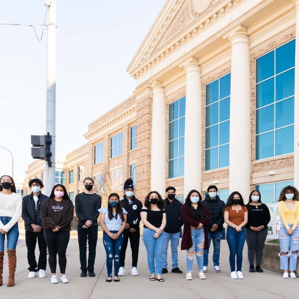 group of high school students standing in row, masked, outside Battle Creek Central High School