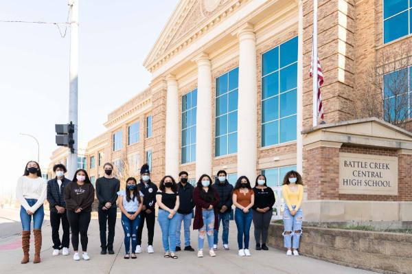 group of high school students, masked, standing outside Battle Creek Central High School
