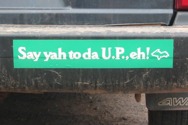 A green bumper sticker says, "Say yah to da U.P., eh!"