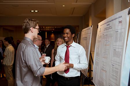 Presenters Gloire Rubambiza, right, and Cameron Bunker talk at the Summer Scholars Showcase August 2 in the DeVos Center.  Photos by Bri Luginbill