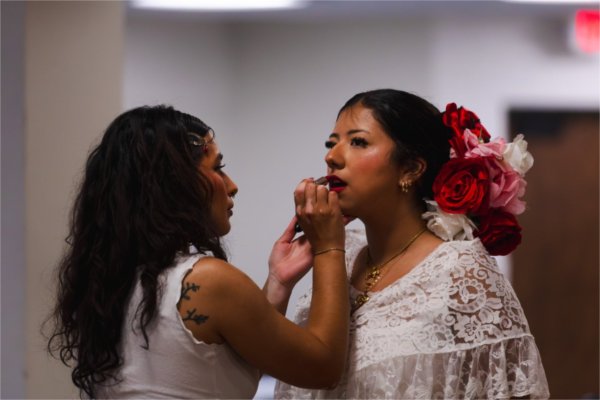 Monarcas dancers prepare to perform. 