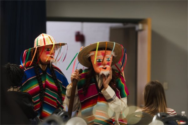 Two students wear the attire of Los Viejitos, or "The Little Old Men", during a fashion show.