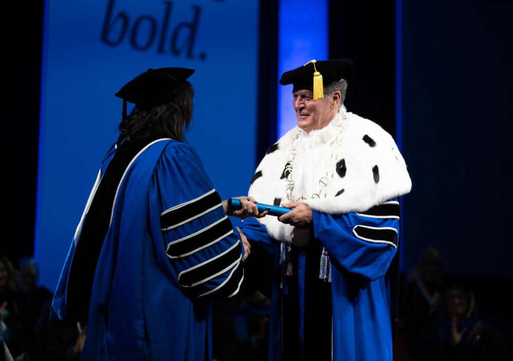 President Emeritus Thomas J. Haas, Grand Valley's fourth president, handed Mantella a baton that had been passed to him by former President Mark A. Murray.