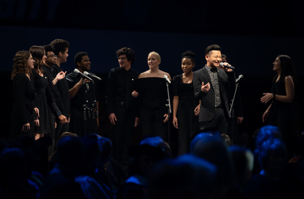 Euphoria, a student acapella group, performs "Feeling Good" during the investiture ceremony.