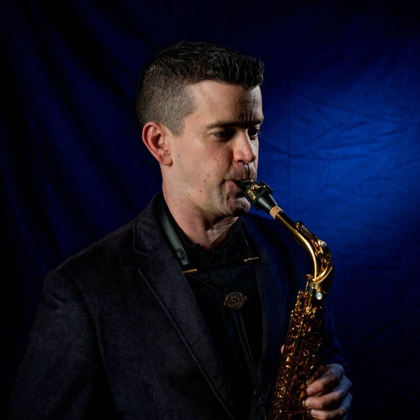 A person plays a saxophone.