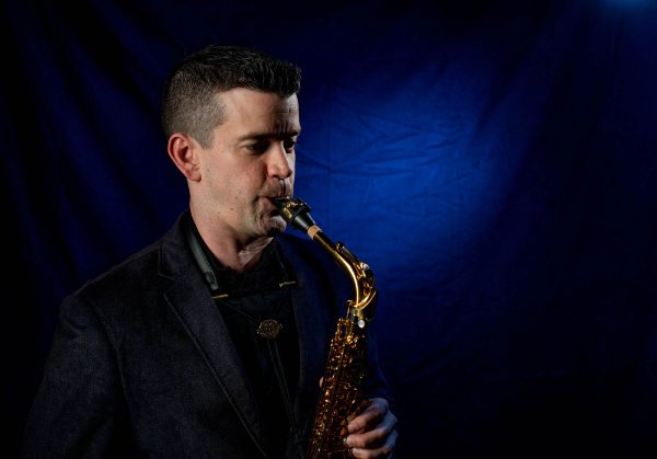 A person plays a saxophone.
