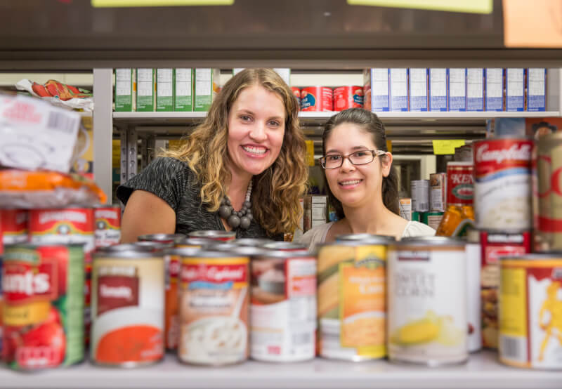 Alumnae Rachael DeWitt, left, and Susana Villagomez-Barajas founded the student food pantry and returned September 22 to celebrate its new location in Kirkhof Center.