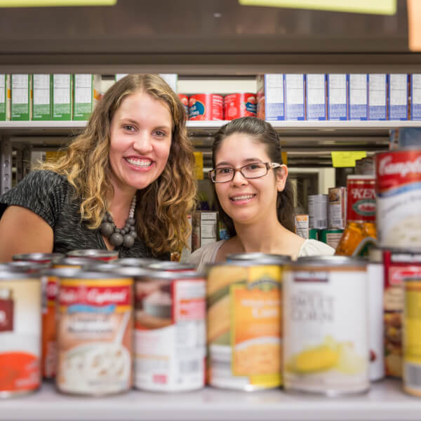 Alumnae Rachael DeWitt, left, and Susana Villagomez-Barajas founded the student food pantry and returned September 22 to celebrate its new location in Kirkhof Center.
