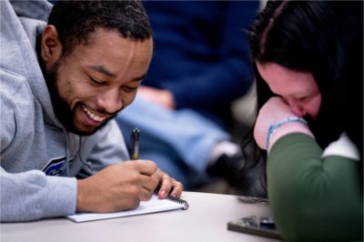 Communication studies student Demant&#233; Phillips, left, and Lexi Green, a first-year elementary education student, right, laugh together during the first meeting of the semester for the speech and debate team January 30.