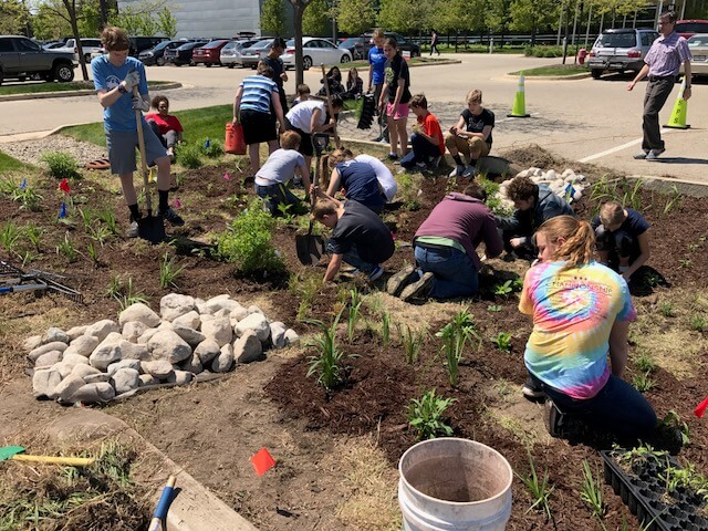 As part of a Groundswell initiative, students from Crestwood Middle School in Kentwood create a native plant garden on the Steelcase campus.
