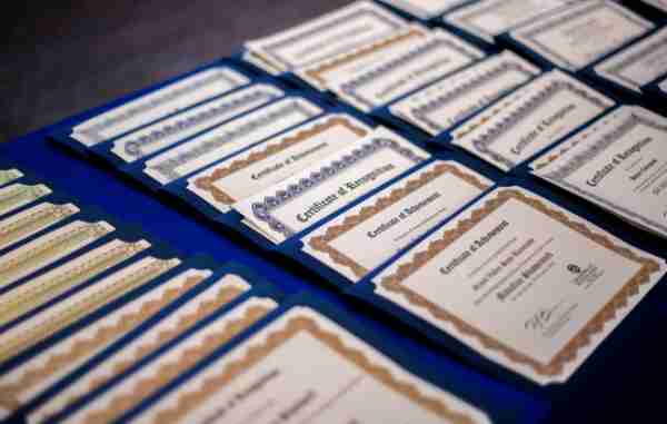 Certificates lie on a table prior to TRIO's Academic Achievement Ceremony.