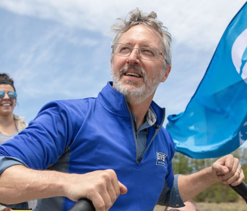 Peter Wampler steers a raft down a river.