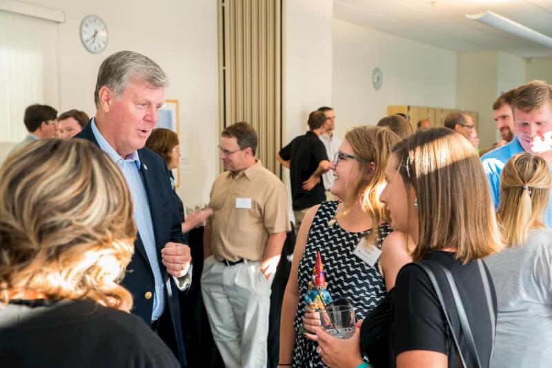 Grand Valley President Thomas J. Haas visits with alumni and students.