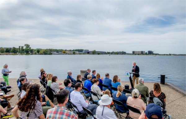 Muskegon government officials, community partners and researchers from the Annis Water Resources Institute gather along the shore of Muskegon Lake to celebrate the lake's removal from the U.S. Environmental Protection Agency's Areas of Concern list.