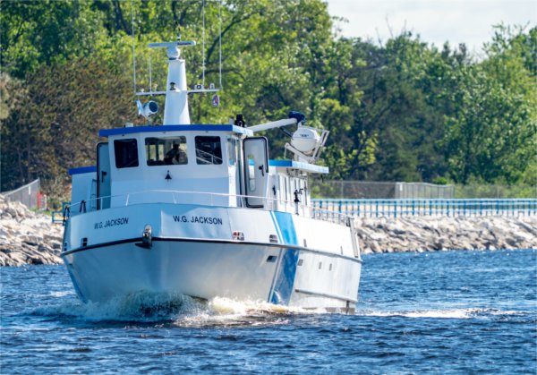 The AWRI's research vessel, the W.G. Jackson, passes through the Muskegon Lake channel en route to Lake Michigan.