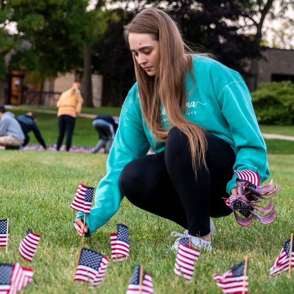Student places U.S. flag in lawn