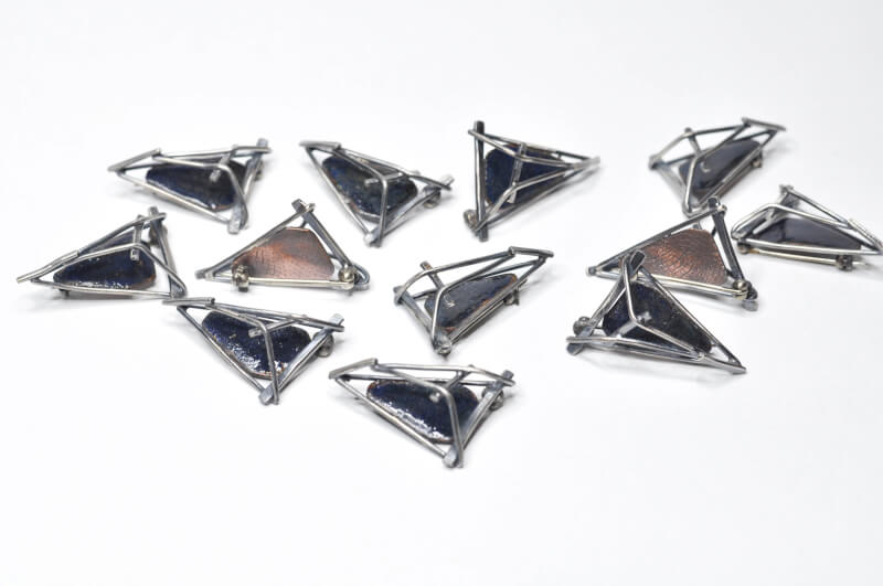 Photo of the 12 pins designed and crafted commemorative pins for the attendees of the Conference for U.S. Women Governors.