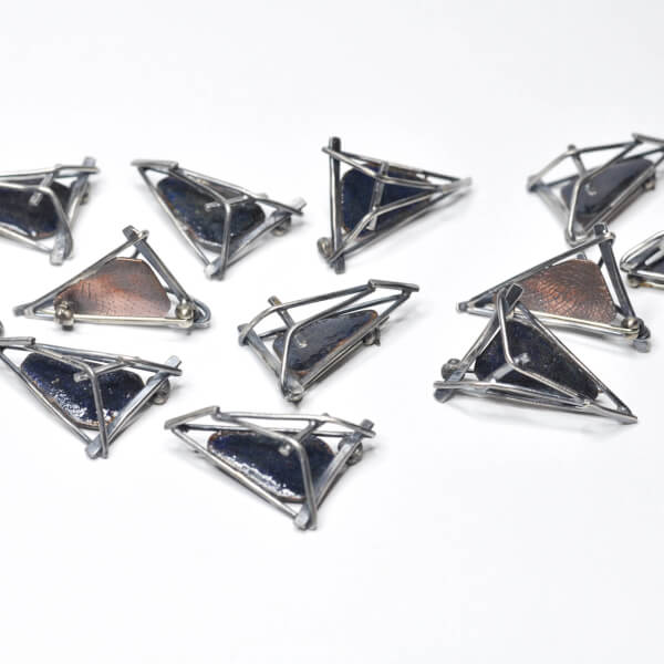 Photo of the 12 pins designed and crafted commemorative pins for the attendees of the Conference for U.S. Women Governors.