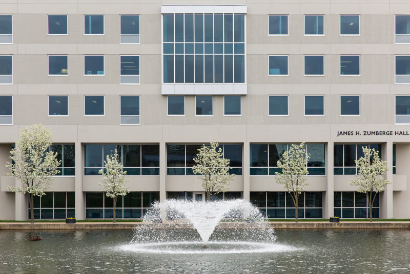 Photo of Zumberge Hall with fountain in front