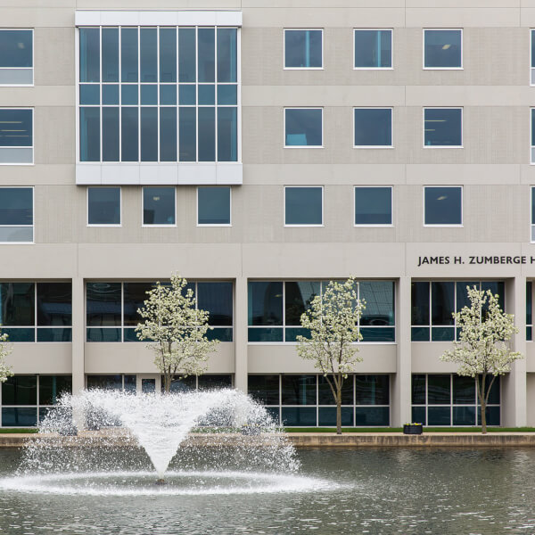 Photo of Zumberge Hall with fountain in front