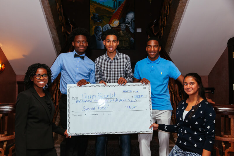 A group of students holds a prize check following the 2016 TESA Detroit competition