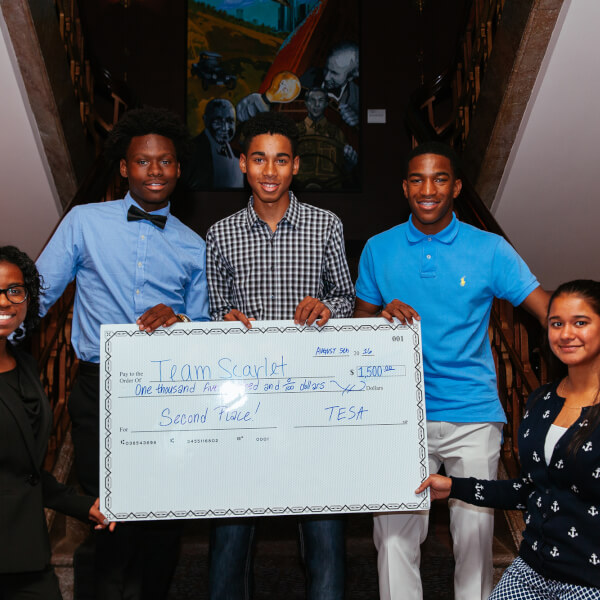 A group of students holds a prize check following the 2016 TESA Detroit competition