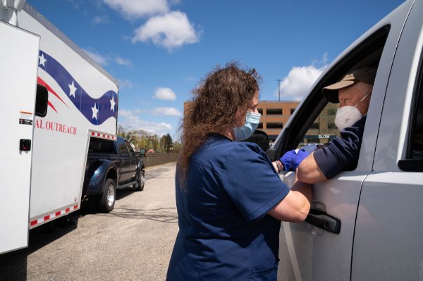 Marine veteran James McKinley receives a COVID-19 vaccine.