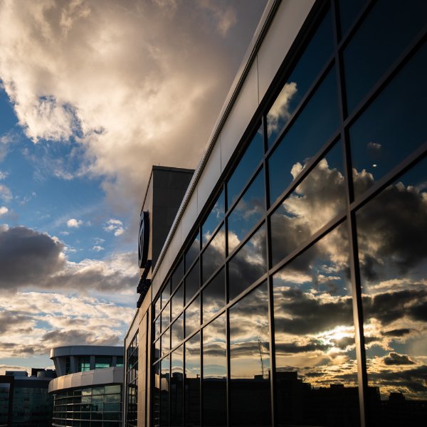 Clouds reflect in the windows of the DeVos Center for Interprofessional Health.