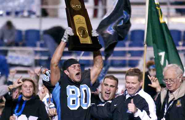 Wide receiver David Kircus lifts the Division II national championship trophy after Grand Valley defeated Valdosta State in 2002.
