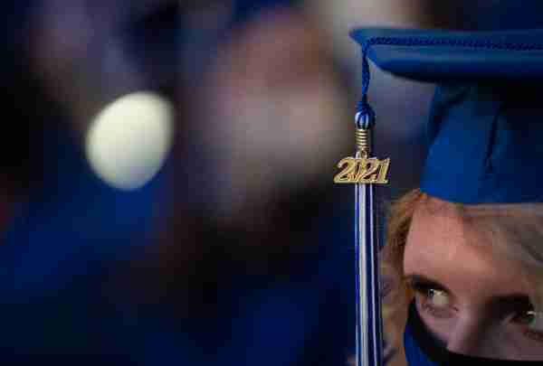 A close up of a student's face at commencement