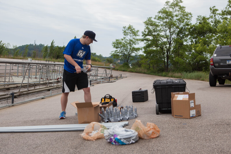  Male student looking through fountain parts