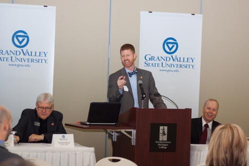 Andrew Booth speaks about the physician assistant program during an event in Traverse City. At right is Timothy Nelson, president of Northwestern Michigan College; Roy Olsson, dean of the College of Health Professions, is at right.
