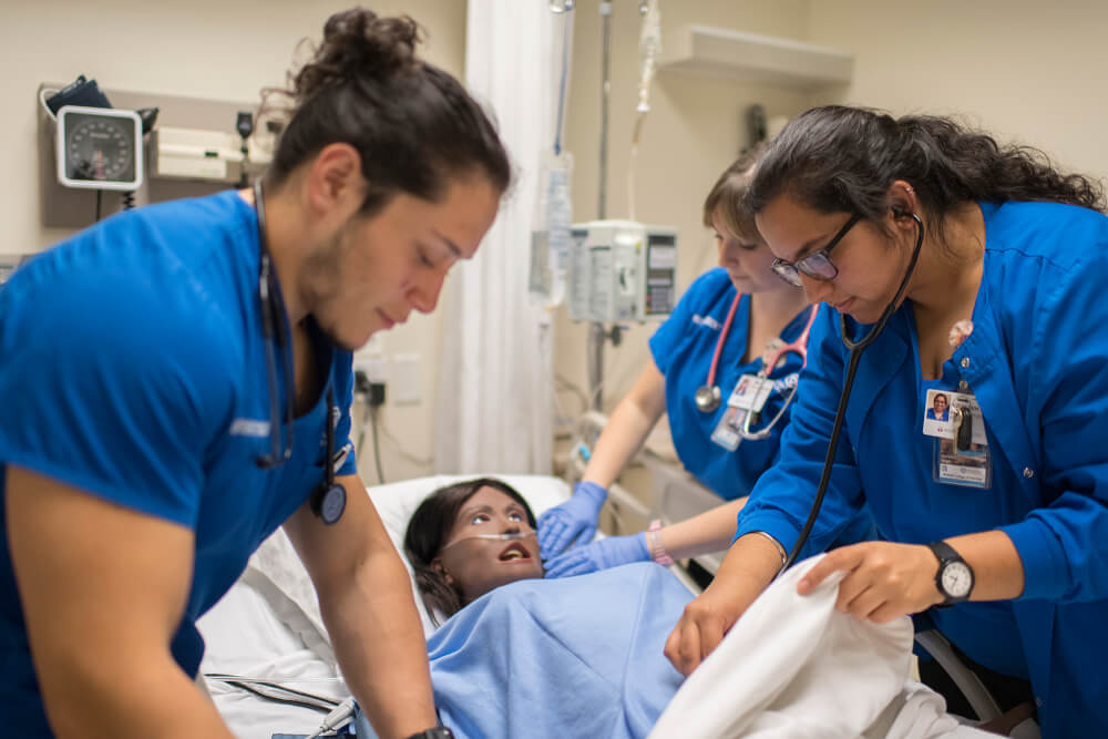 nursing students working with SIM patient