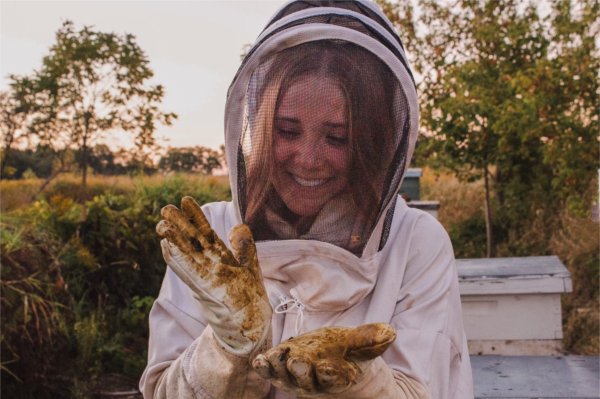 student in beekeeper outfit