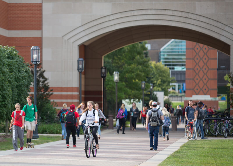 A photo of students walking near the Student Services Center.