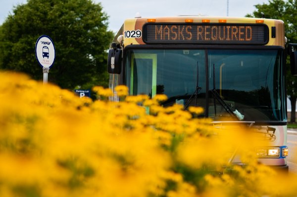 Rapid bus with sign that says masks required 