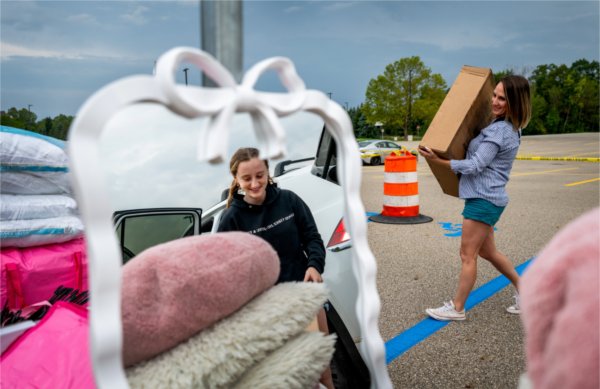 First-year student Riley Graham collects her belongings while her mom, Liza, helps her move into her room at Hoobler Living Center. 