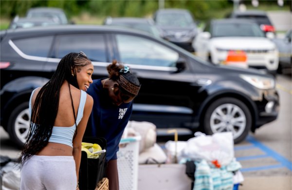 Students collect their belongings before moving into their rooms on campus.